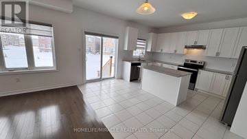 Southgate apartment for rent - A kitchen with white cabinets and a large island in the middle.