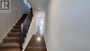 Southgate apartment for rent - A hallway with a staircase and a light at the end.