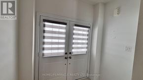 Southgate apartment for rent - A white door with a window and blinds is closed.