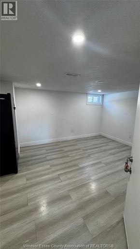 Windsor apartment for rent - A room with a wooden floor and a small window.