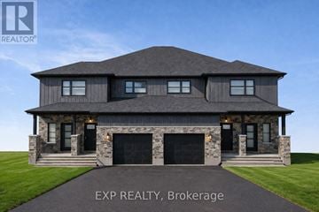 Russell apartment for rent - A large house with a snowy roof and garage doors.