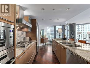 Vancouver apartment for rent - A modern kitchen with wooden cabinets and stainless steel appliances.