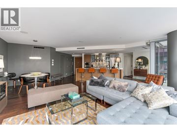 Vancouver apartment for rent - A living room with a grey couch and a glass coffee table.