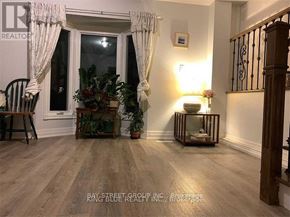 Toronto (Agincourt North) apartment for rent - A room with wooden floors and a window with curtains.