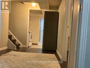 Toronto (Agincourt North) apartment for rent - A hallway with a refrigerator and stairs.