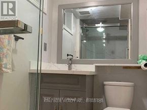Toronto (Agincourt North) apartment for rent - A bathroom with a toilet, sink and mirror.