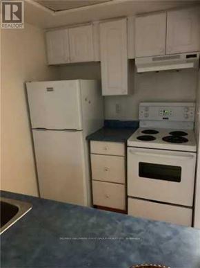 Toronto (Eglinton East) condo for rent - A kitchen with white appliances and cabinets.