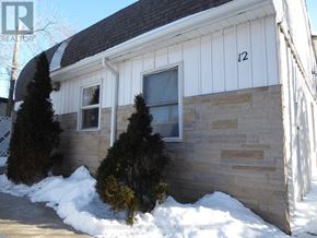Halton Hills (Georgetown) apartment for rent - A house with a white siding and a stone wall.