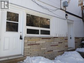 Halton Hills (Georgetown) apartment for rent - A white door with a black handle is on a brick wall.
