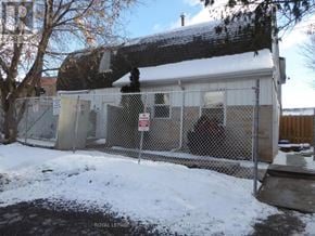 Halton Hills (Georgetown) apartment for rent - A snow-covered yard with a fence and a sign.
