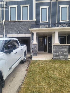 Brantford townhouse for rent - A white truck is parked in front of a house.