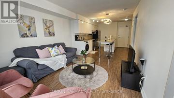 Toronto (Bayview Village) condo for rent - A living room with a grey couch and a coffee table.