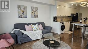 Toronto (Bayview Village) condo for rent - A living room with a grey couch and a coffee table.