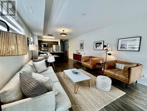 Collingwood condo for rent - A living room with a couch, a chair, and a coffee table.