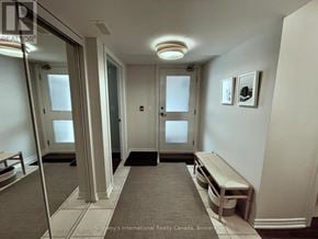 Collingwood condo for rent - A hallway with a bench and a door at the end.