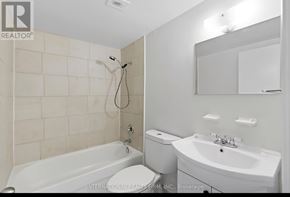 Hamilton (Stinson) multi-family for rent - A white bathroom with a tub, toilet, and sink.