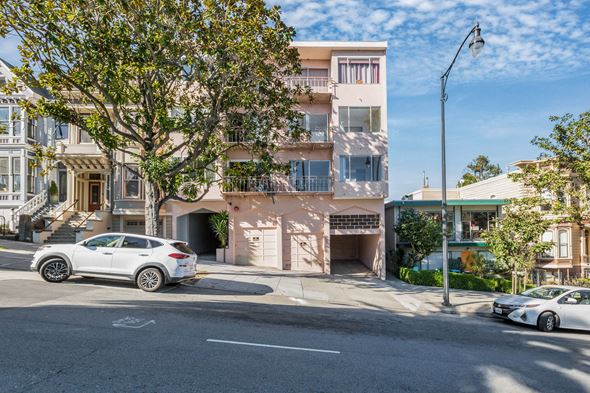 San Francisco apartment for rent - A white car is parked on the street in front of a building.
