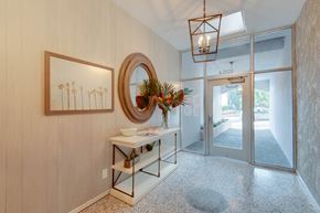 San Francisco apartment for rent - A room with a wooden wall and a framed picture of palm trees.