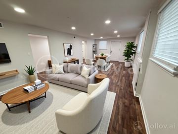 Nashville apartment for rent - A modern living room with a wooden coffee table and a grey sofa.