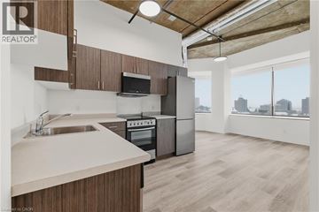 Kitchener condo for rent - A kitchen with wooden cabinets and a stainless steel oven.