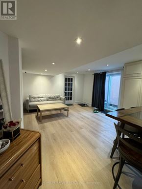 Richmond Hill (South Richvale) apartment for rent - A living room with a couch, a coffee table, and a dining table.