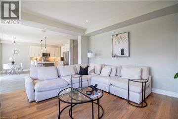Ancaster apartment for rent - A living room with a white couch and a glass coffee table.