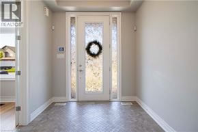 Ancaster apartment for rent - A doorway with a wreath on the door and a sign on the wall.