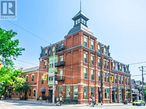 Toronto (Cabbagetown-South St. James Town) condo for rent - A large red brick building with a clock tower on the corner.