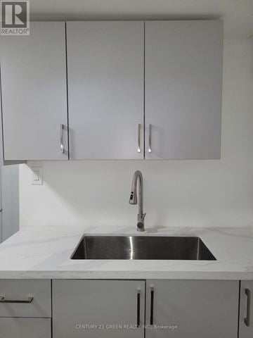 Brampton (Central Park) apartment for rent - A white kitchen with a sink and cabinets.