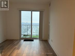 Toronto (Willowdale West) condo for rent - A room with a large window overlooking a cityscape.