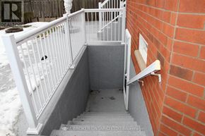 Vaughan (Maple) apartment for rent - A stairway with a white railing and a brick wall.