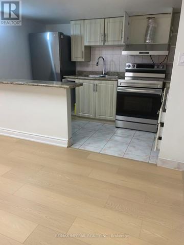 Mississauga (Hurontario) apartment for rent - A kitchen with a refrigerator, oven, and sink.