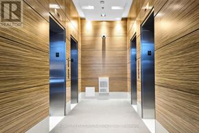 Toronto (Bayview Village) condo for rent - A hallway with wooden walls and blue doors.