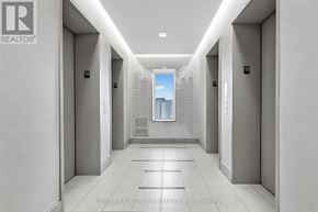 Toronto (Bayview Village) condo for rent - A hallway with a view of a building outside the window.