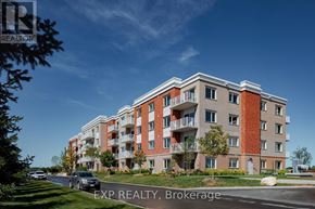 Renfrew condo for rent - A large apartment building with a car parked in front.