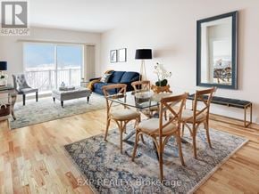 Renfrew condo for rent - A living room with a glass table and chairs.