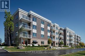 Renfrew condo for rent - A large apartment building with multiple balconies and a clear blue sky in the background.