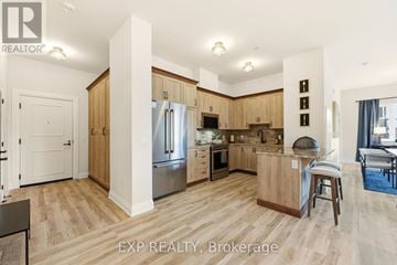 Carleton Place condo for rent - A kitchen with wooden cabinets and a white fridge.