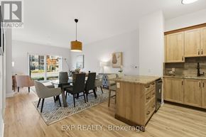 Carleton Place condo for rent - A modern kitchen with wooden cabinets and a dining table with chairs.