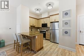 Carleton Place condo for rent - A kitchen with wooden cabinets and a stainless steel refrigerator.