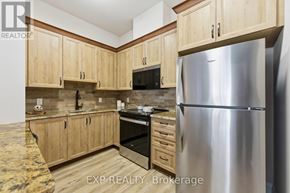 Carleton Place condo for rent - A kitchen with wooden cabinets and a stainless steel refrigerator.