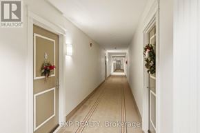 Carleton Place condo for rent - A long hallway with a Christmas wreath on the door.