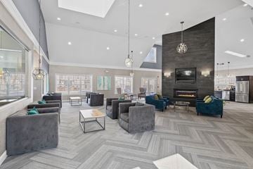 Danbury townhouse for rent - A modern living room with grey couches and a fireplace.