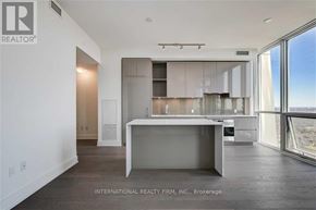 Toronto (Annex) condo for rent - A modern kitchen with a large island in the middle.