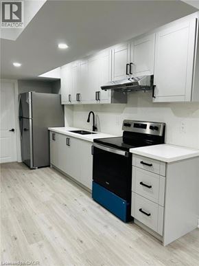 Kitchener apartment for rent - A modern kitchen with white cabinets and a blue drawer.