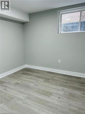 Kitchener apartment for rent - A room with a window and wooden flooring.