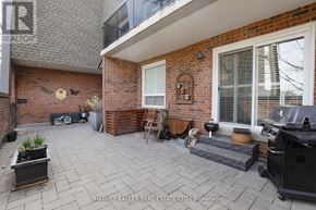 Toronto (Humber Heights) townhouse for rent - A brick house with a patio and a grill.