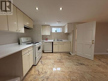 Toronto (Wexford-Maryvale) apartment for rent - A kitchen with beige cabinets and a tiled floor.