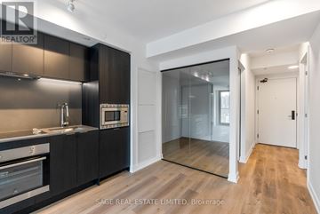 Hamilton (Beasley) condo for rent - A modern kitchen with dark brown cabinets and stainless steel appliances.