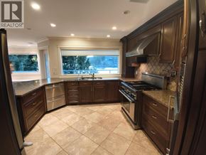 Belcarra apartment for rent - A well-lit kitchen with dark wood cabinets and a tiled floor.